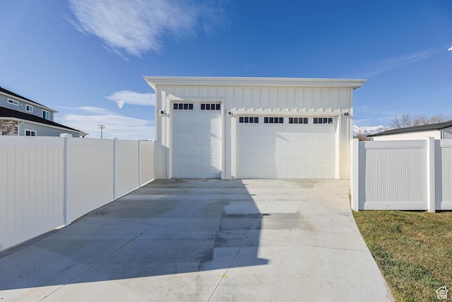 detached garage featuring fence