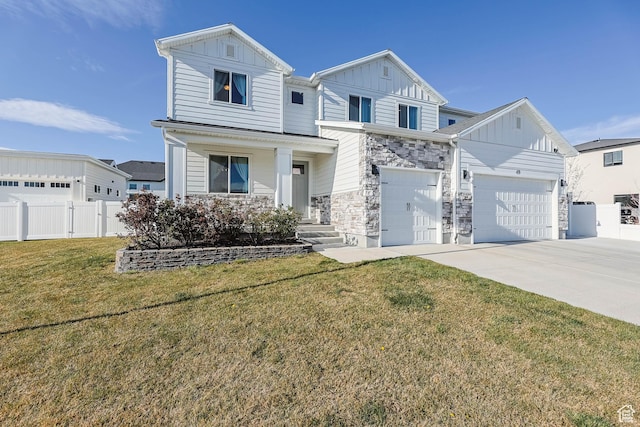 view of front facade with board and batten siding, a front yard, stone siding, fence, and concrete driveway