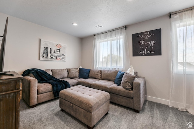 carpeted living room with visible vents, baseboards, recessed lighting, and a textured ceiling