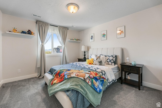 carpeted bedroom featuring visible vents, baseboards, and a textured ceiling