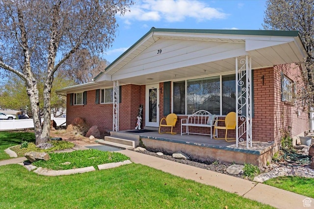 39 S 200 W, Morgan, UT 84050 - ranch-style home with covered porch, a front yard, and brick siding