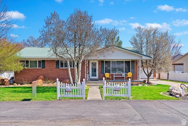 39 S 200 W, Morgan, UT 84050 - view of front facade featuring brick siding, fence, and a front lawn