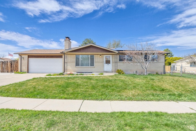 4926 S 3655 W, Taylorsville, UT 84129 - ranch-style home with solar panels, a garage, fence, concrete driveway, and brick siding