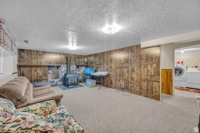 4926 S 3655 W, Taylorsville, UT 84129 - interior space featuring a wood stove, a textured ceiling, wooden walls, washer and clothes dryer, and carpet flooring
