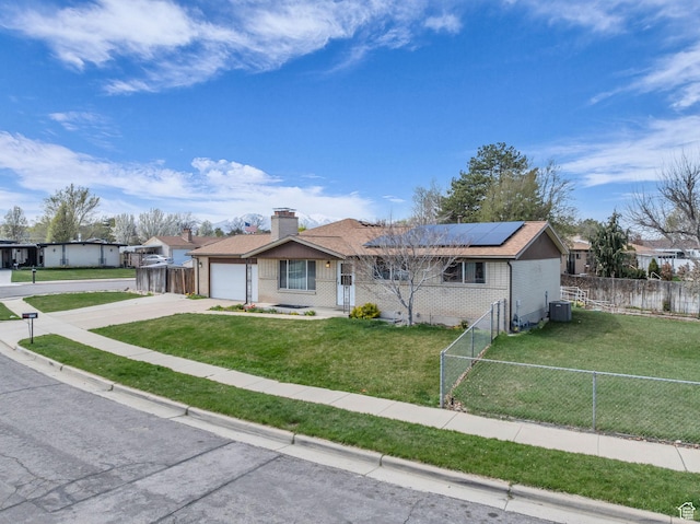 4926 S 3655 W, Taylorsville, UT 84129 - view of front of property featuring a front yard, an attached garage, fence private yard, central air condition unit, and driveway