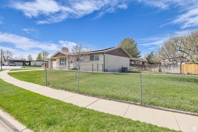 4926 S 3655 W, Taylorsville, UT 84129 - view of front of house featuring a front yard, brick siding, a chimney, and a fenced front yard
