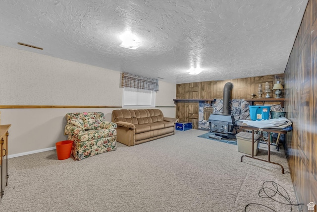 4926 S 3655 W, Taylorsville, UT 84129 - living room featuring baseboards, a wood stove, a textured ceiling, wooden walls, and carpet flooring