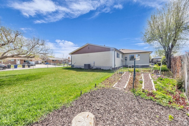 4926 S 3655 W, Taylorsville, UT 84129 - exterior space with central AC unit, a vegetable garden, fence, and a lawn