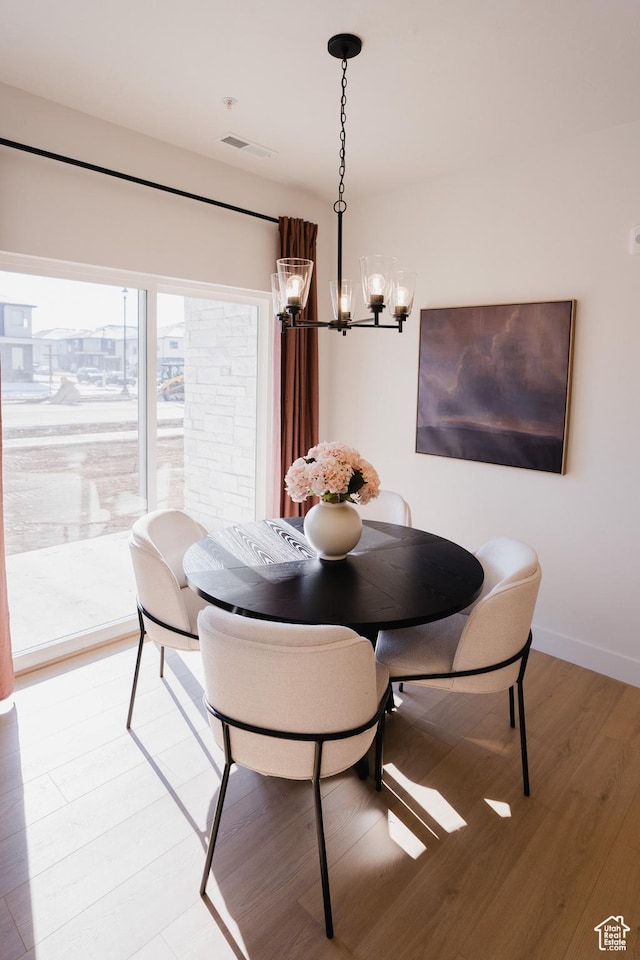 216 E 850 S Unit 6-101, Spanish Fork, UT 84660 - dining room with visible vents, baseboards, light wood finished floors, and a notable chandelier