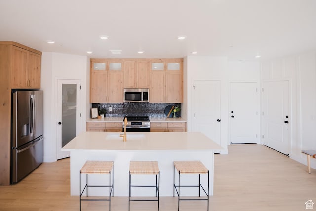 216 E 850 S Unit 6-101, Spanish Fork, UT 84660 - kitchen with light countertops, appliances with stainless steel finishes, light wood finished floors, and light brown cabinets