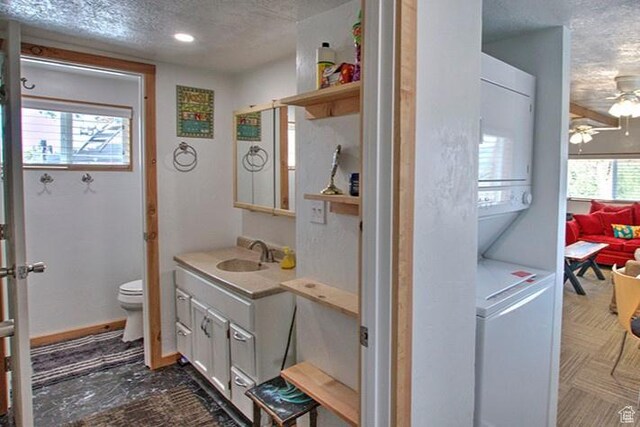 1559 S Bear Lake Blvd S, Garden City, UT 84028 - bathroom featuring toilet, a textured ceiling, vanity, and a ceiling fan