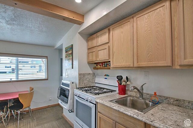 1559 S Bear Lake Blvd S, Garden City, UT 84028 - kitchen featuring baseboards, light brown cabinets, a sink, heating unit, and white gas range