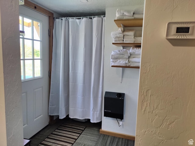 1559 S Bear Lake Blvd S, Garden City, UT 84028 - doorway featuring baseboards, heating unit, plenty of natural light, and a textured wall