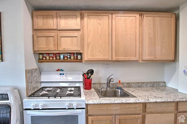 1559 S Bear Lake Blvd S, Garden City, UT 84028 - kitchen featuring white gas range oven, open shelves, washer / dryer, a sink, and light brown cabinetry