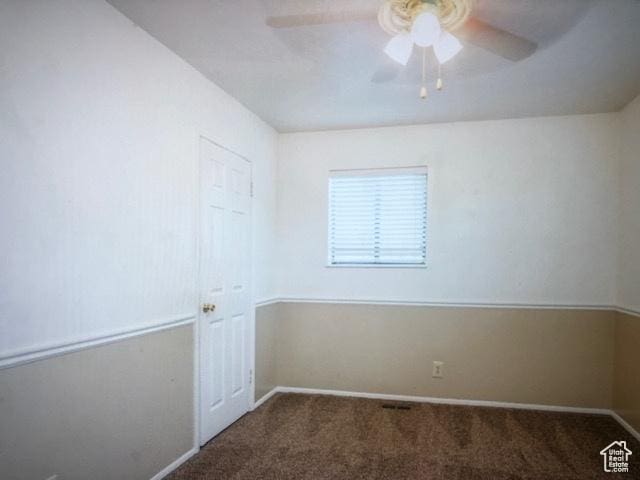 spare room featuring ceiling fan, baseboards, and carpet flooring