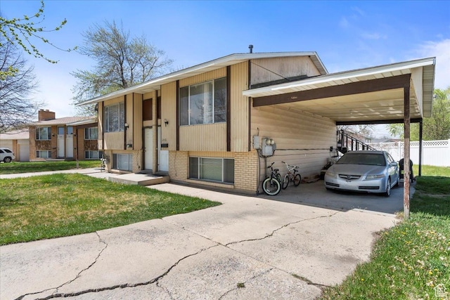250 N 350 E, Orem, UT 84057 - bi-level home featuring brick siding, a front yard, an attached carport, and concrete driveway