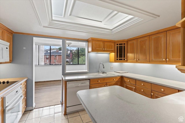 kitchen with white appliances, glass insert cabinets, light tile patterned flooring, brown cabinetry, and a sink