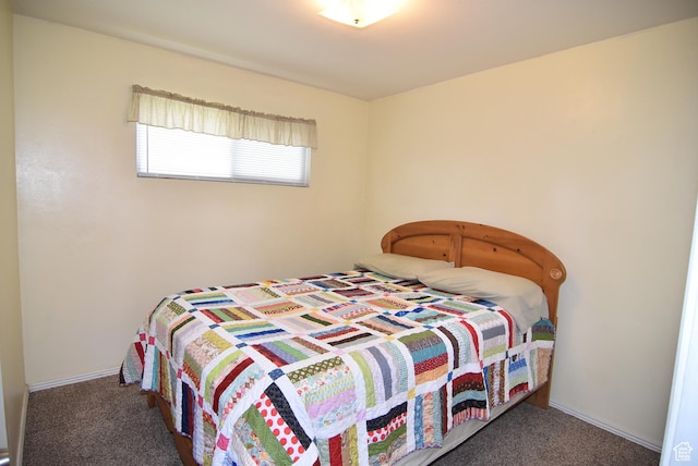 carpeted bedroom featuring baseboards