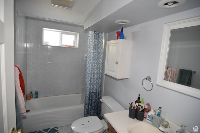 bathroom with shower / bathtub combination with curtain, vanity, and toilet