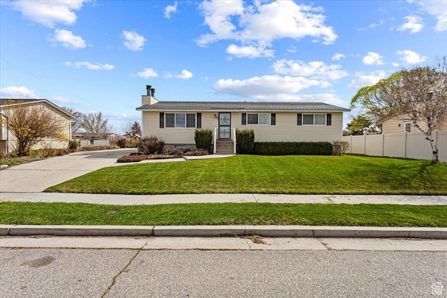 single story home with a chimney, concrete driveway, fence, and a front lawn