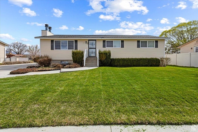 ranch-style home featuring a chimney, fence, and a front lawn