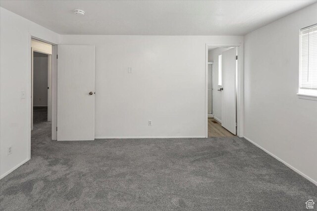 spare room featuring baseboards and carpet flooring