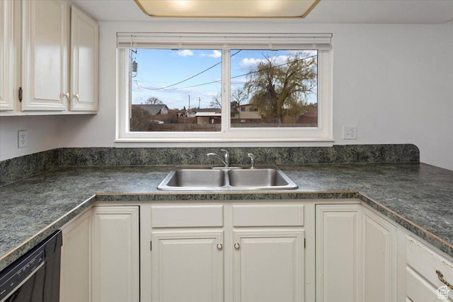 kitchen featuring a sink, white cabinets, dark countertops, and dishwasher