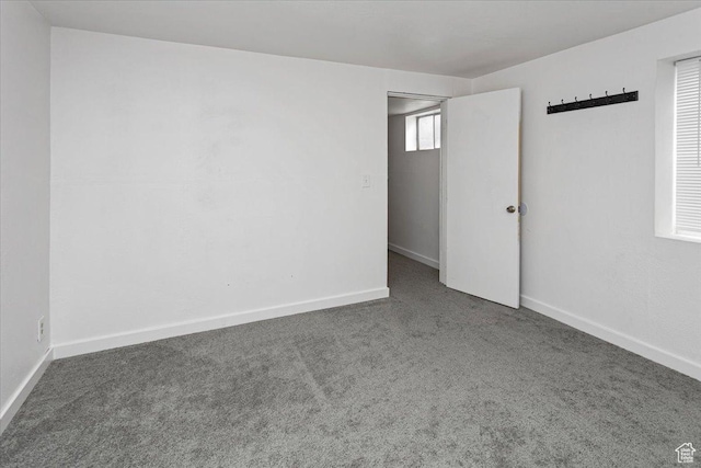 carpeted empty room with baseboards