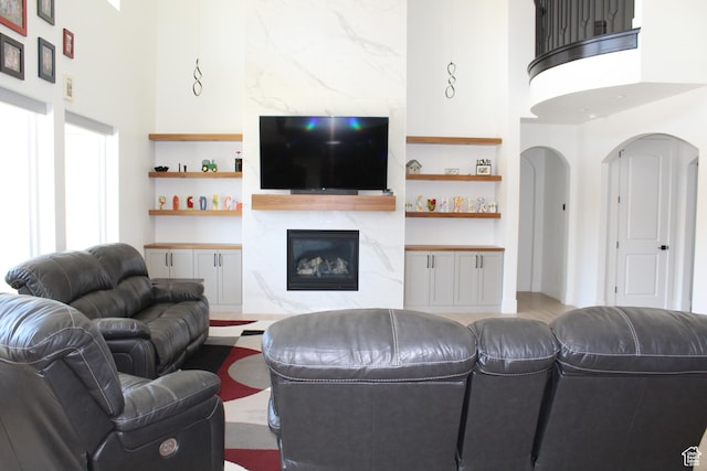 2892 E 1400 S, St George, UT 84790 - living room featuring a premium fireplace, built in features, a towering ceiling, and arched walkways