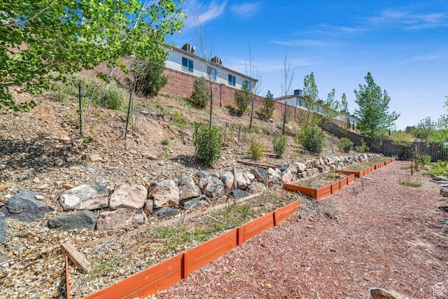 view of yard with a garden and fence