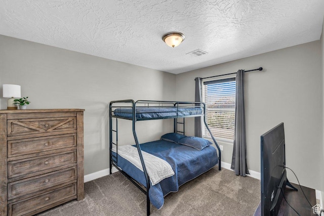 carpeted bedroom featuring a textured ceiling, baseboards, and visible vents