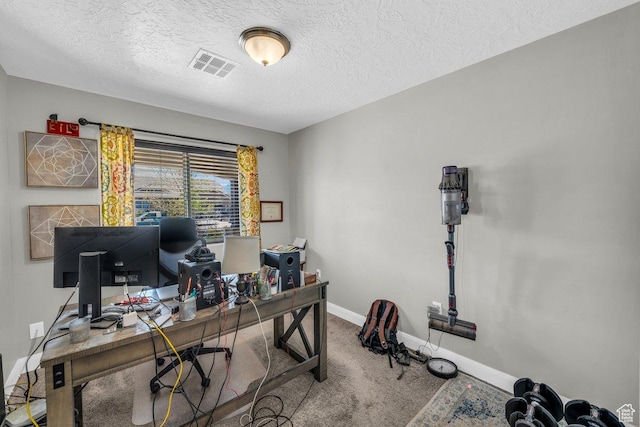 carpeted office space featuring visible vents, baseboards, and a textured ceiling