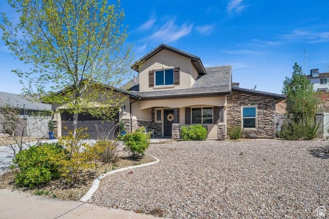 view of front facade with a garage, stucco siding, stone siding, and fence