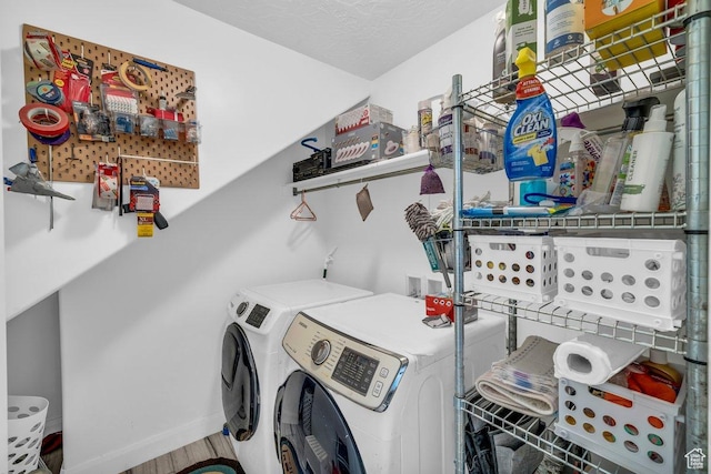clothes washing area with washer and clothes dryer, laundry area, and baseboards