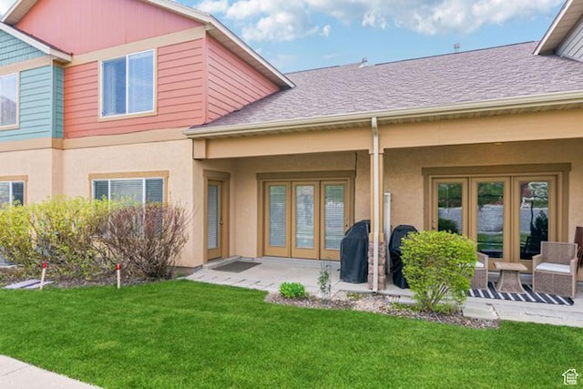 896 W Waterside Dr, Farmington, UT 84025 - back of property featuring roof with shingles, a patio area, stucco siding, and a lawn
