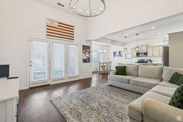 896 W Waterside Dr, Farmington, UT 84025 - living room featuring baseboards, dark wood-style flooring, a notable chandelier, and visible vents