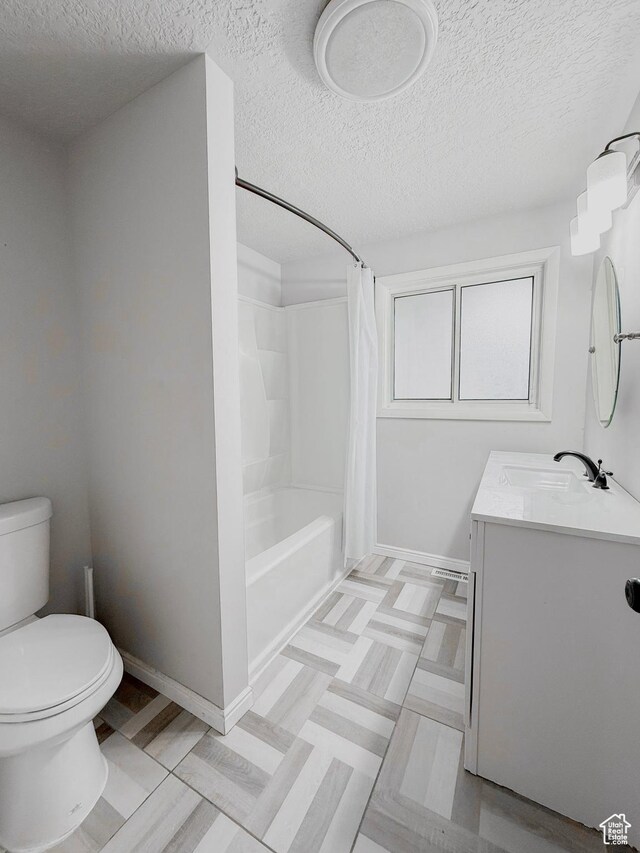 4503 S 2025 W, Roy, UT 84067 - full bath with a textured ceiling, vanity, shower / tub combo with curtain, baseboards, and toilet