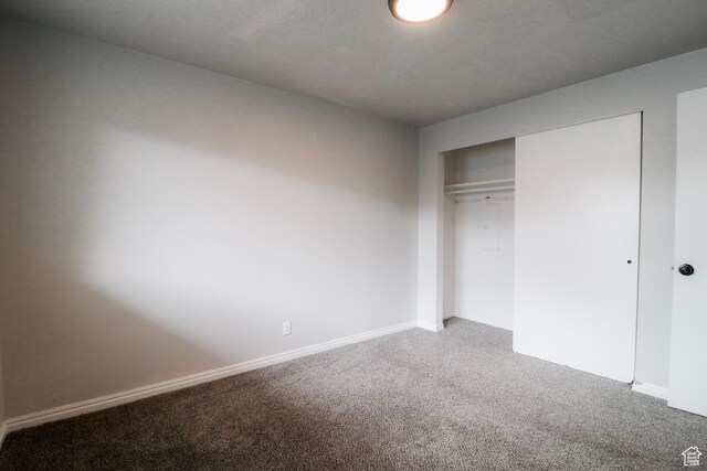 4503 S 2025 W, Roy, UT 84067 - unfurnished bedroom featuring baseboards, a closet, and light colored carpet