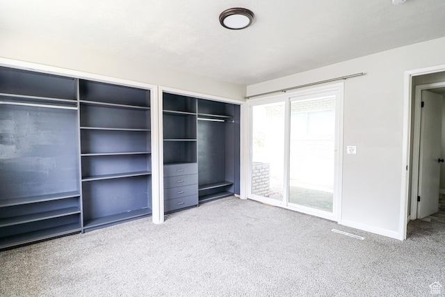 4503 S 2025 W, Roy, UT 84067 - unfurnished bedroom with baseboards, carpet floors, and two closets