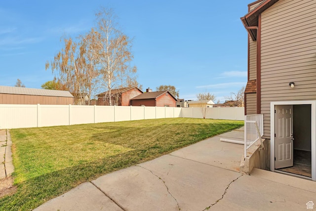 view of yard with fence and a patio