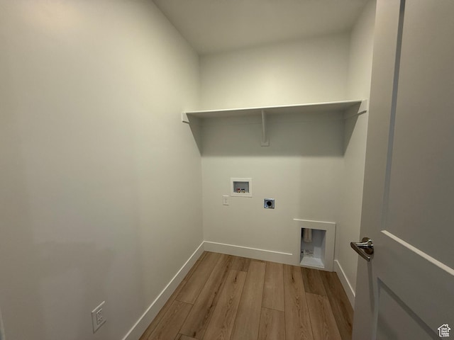 laundry area with light wood-style floors, hookup for a washing machine, hookup for an electric dryer, and baseboards