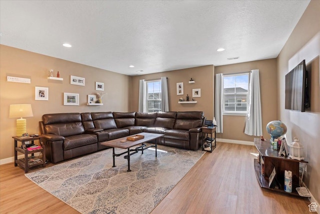 12133 S Broken Arch Ln, Herriman, UT 84096 - living area with wood finished floors, baseboards, and a wealth of natural light