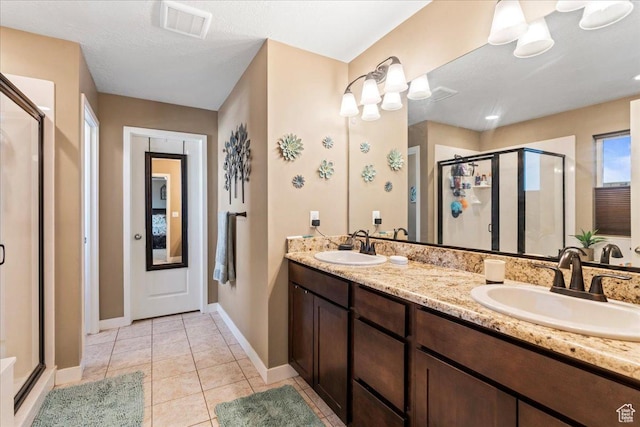 12133 S Broken Arch Ln, Herriman, UT 84096 - full bath featuring a sink, tile patterned flooring, double vanity, and a stall shower