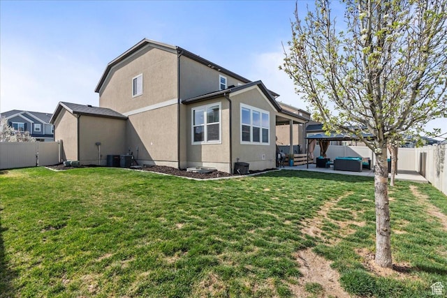 12133 S Broken Arch Ln, Herriman, UT 84096 - back of house featuring a patio area, a fenced backyard, a yard, and an outdoor hangout area