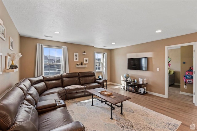 12133 S Broken Arch Ln, Herriman, UT 84096 - living area with wood finished floors, baseboards, visible vents, and recessed lighting