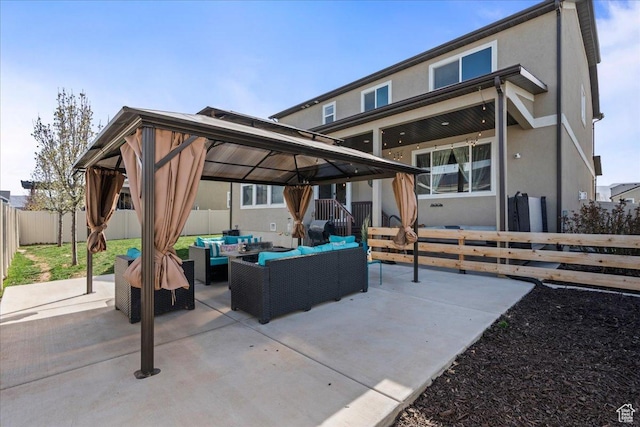 12133 S Broken Arch Ln, Herriman, UT 84096 - rear view of property featuring outdoor lounge area, a gazebo, a fenced backyard, and stucco siding