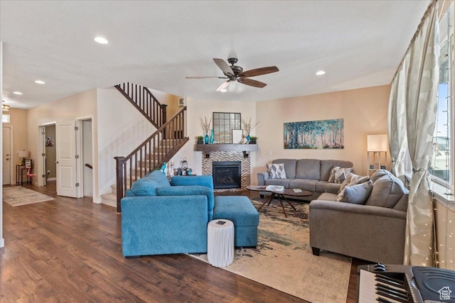 12133 S Broken Arch Ln, Herriman, UT 84096 - living area with ceiling fan, recessed lighting, wood finished floors, a tiled fireplace, and stairs