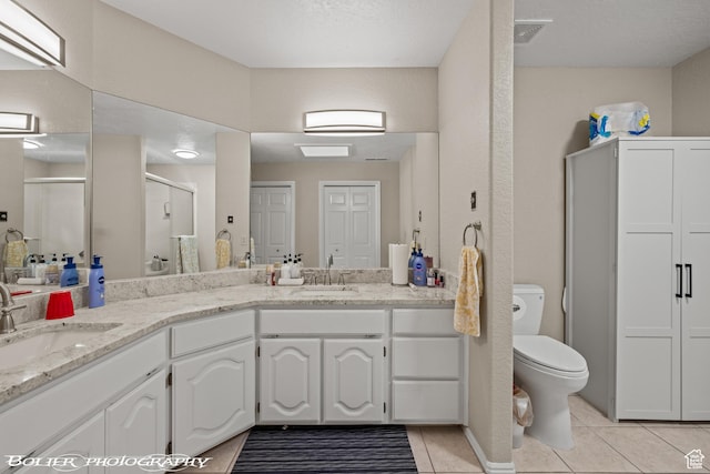 bathroom with a shower stall, tile patterned floors, visible vents, and a sink