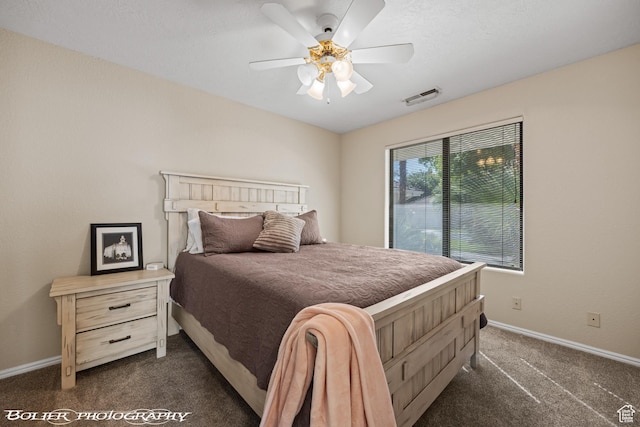 bedroom with dark colored carpet, visible vents, baseboards, and a ceiling fan