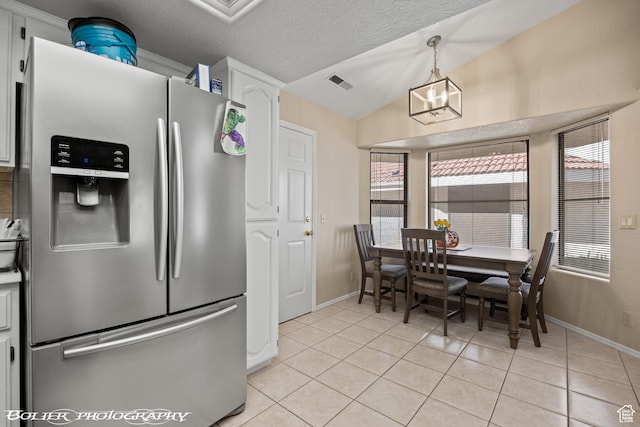 kitchen with stainless steel fridge with ice dispenser, visible vents, baseboards, white cabinets, and light tile patterned flooring